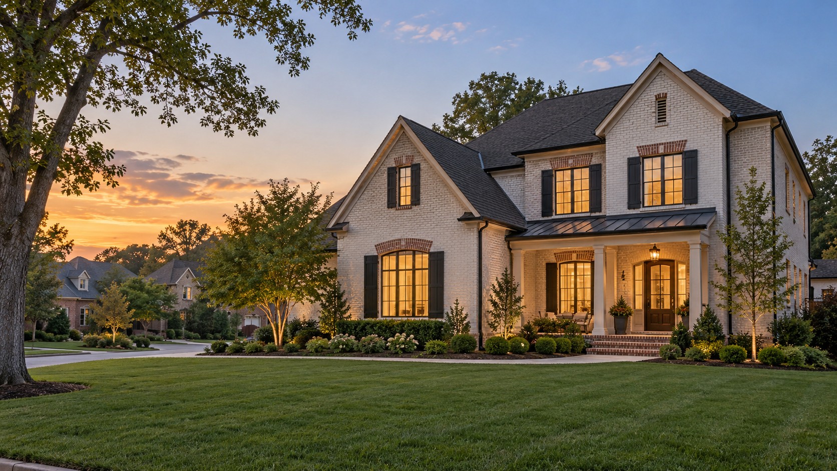 Illustrative Chesapeake inspired brick home with a landscaped lawn at sunset